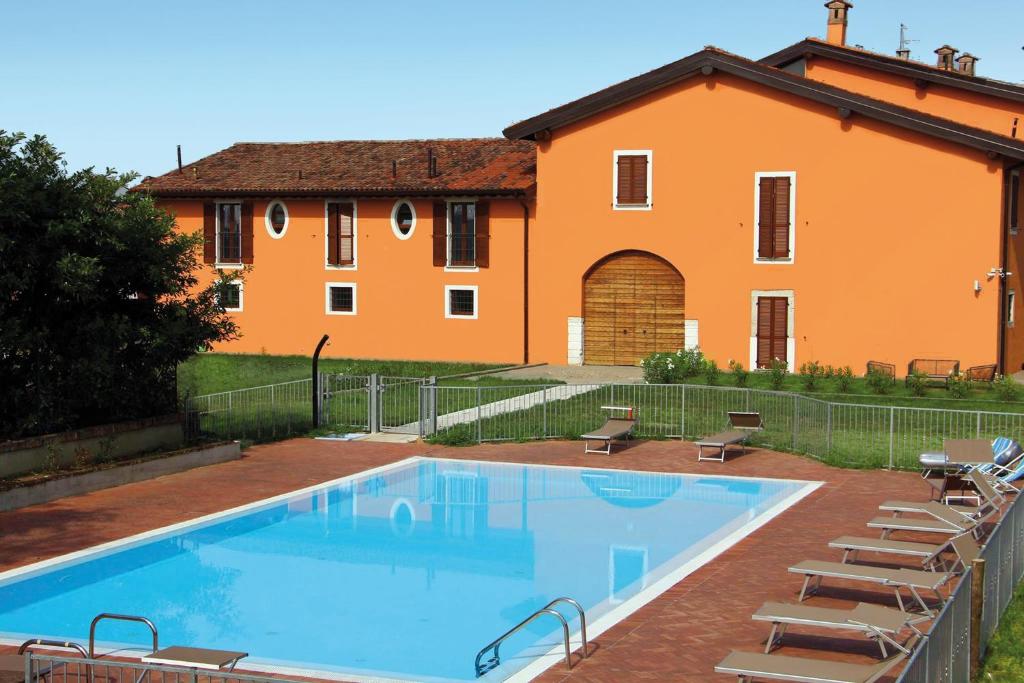 a large swimming pool in front of a house at Cascina Volta in Brescia