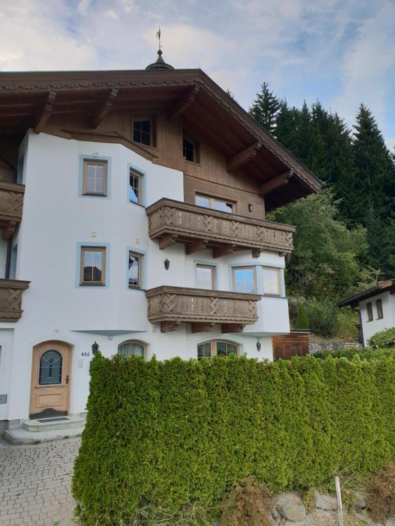 a white house with a brown roof at Chalet Bergzauber by PiaundDirk in Hippach