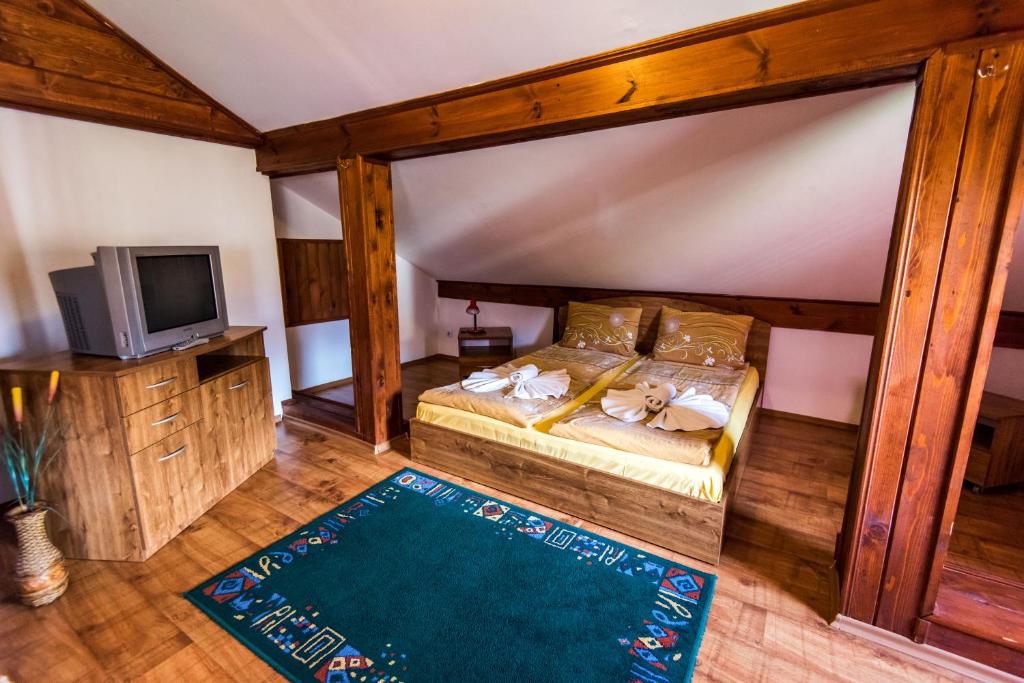 a bedroom with a bed with a baseball bat on it at Vien Guest House in Bansko