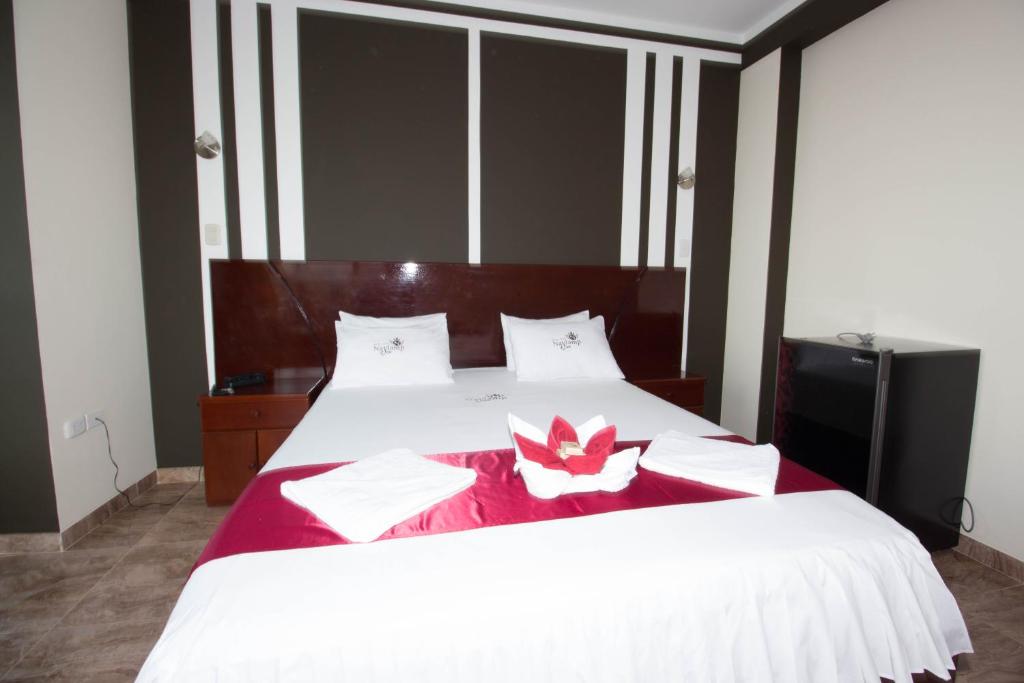 Postel nebo postele na pokoji v ubytování Hotel Suite Naylamp Zyon