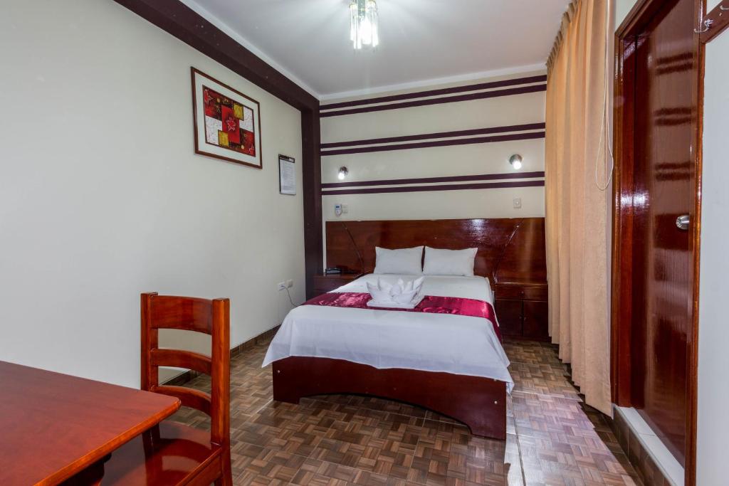 Postel nebo postele na pokoji v ubytování Hotel Suite Naylamp Zyon