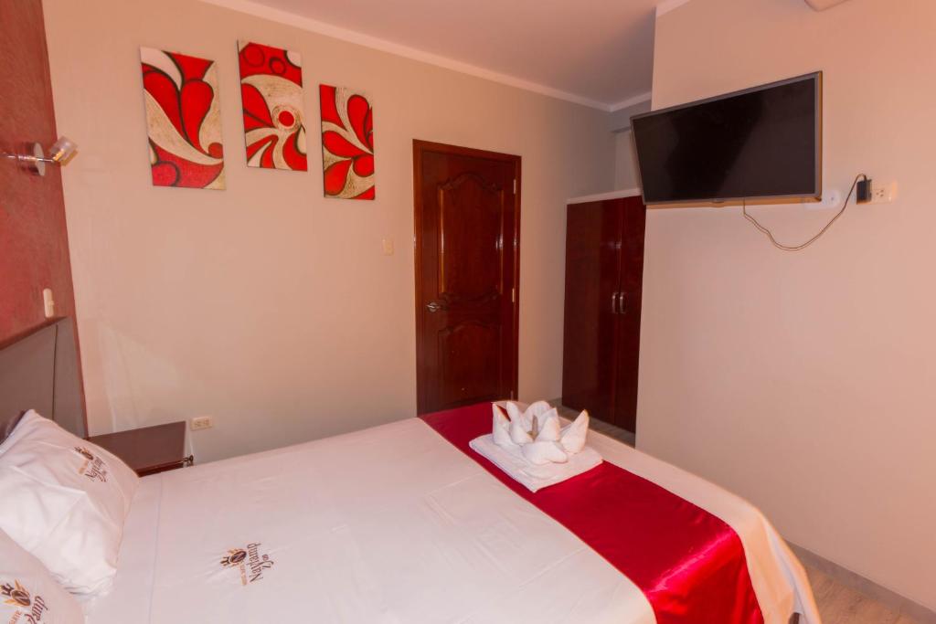 Postel nebo postele na pokoji v ubytování Hotel Suite Naylamp Zyon