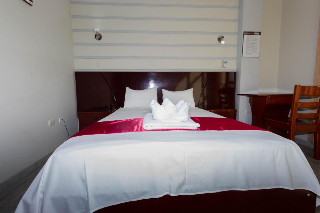 Postel nebo postele na pokoji v ubytování Hotel Suite Naylamp Zyon