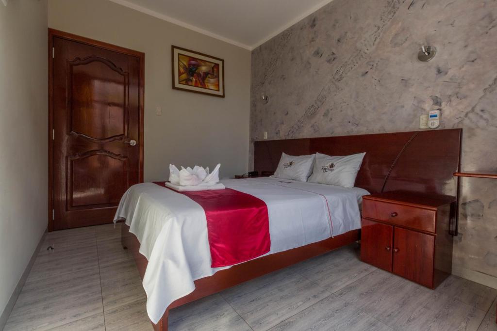 Postel nebo postele na pokoji v ubytování Hotel Suite Naylamp Zyon
