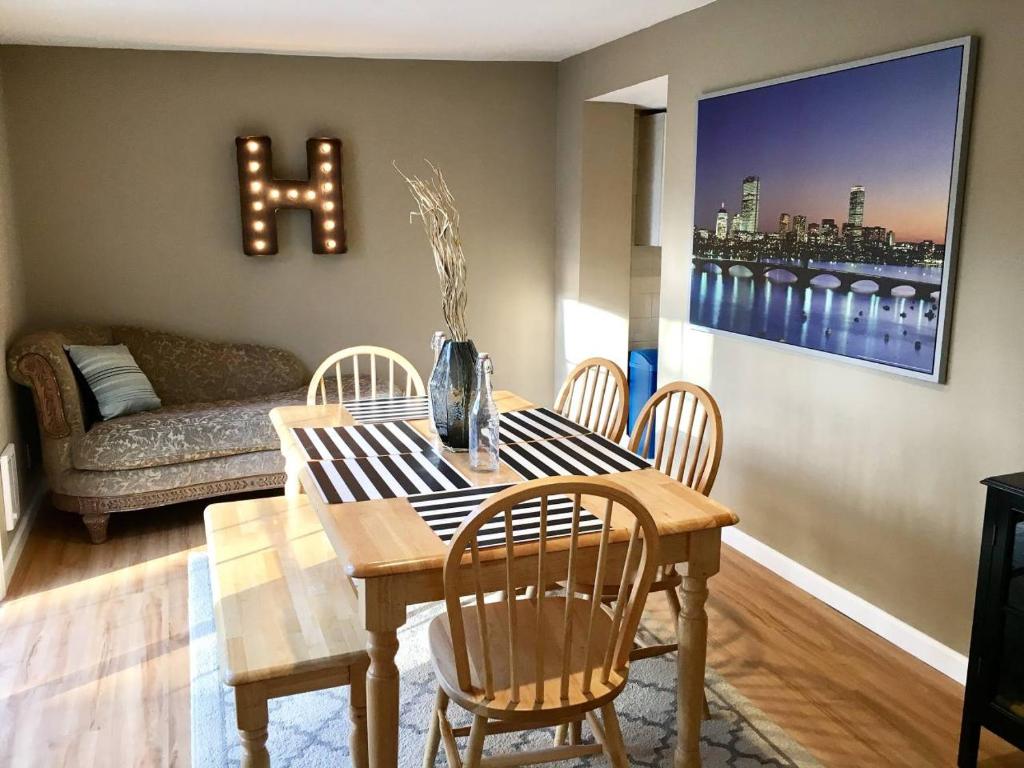 a dining room with a table and chairs and a couch at ~*Pet Friendly 30min to Downtown*~ THE BOSTONIAN in Boston