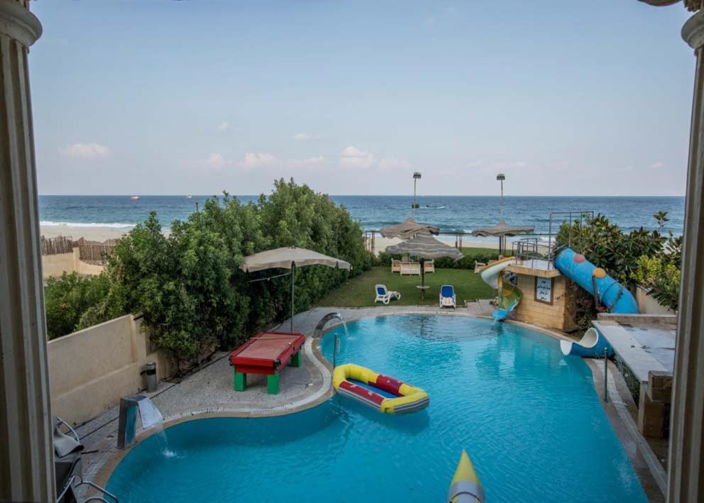a large swimming pool with a water park at Resort altayar Villa altayar 1 Aqua Park with Sea View in Sidi Kirayr