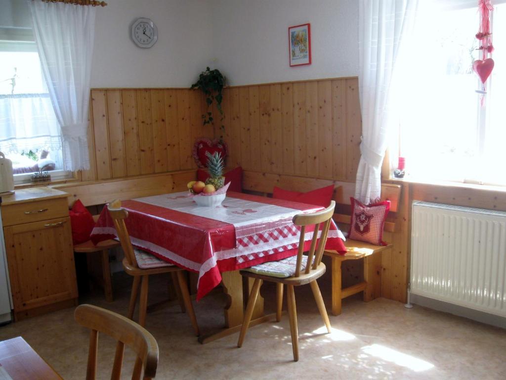 a kitchen with a table with a red table cloth on it at Haus Klinger in Gaschurn