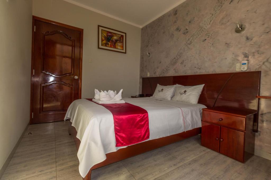 Postel nebo postele na pokoji v ubytování Hotel Suite Naylamp Zyon