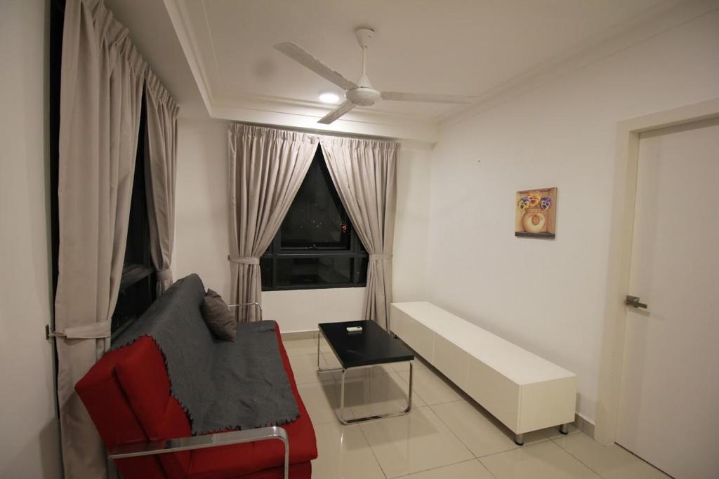 a living room with a couch and a window at Abz Apartment @ Solstice in Cyberjaya