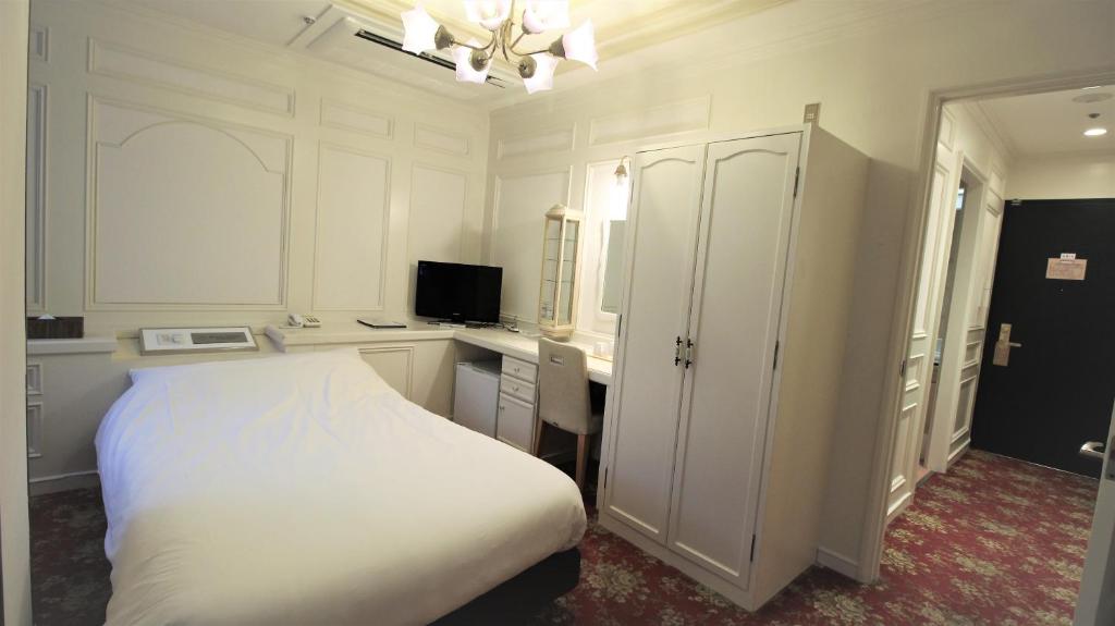 Postel nebo postele na pokoji v ubytování Royal Hotel Shinokubo