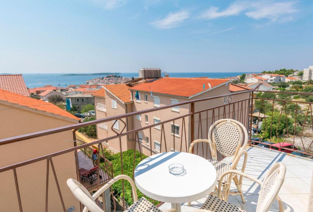 a balcony with a table and chairs and a view at Apartments Jere Proto in Primošten