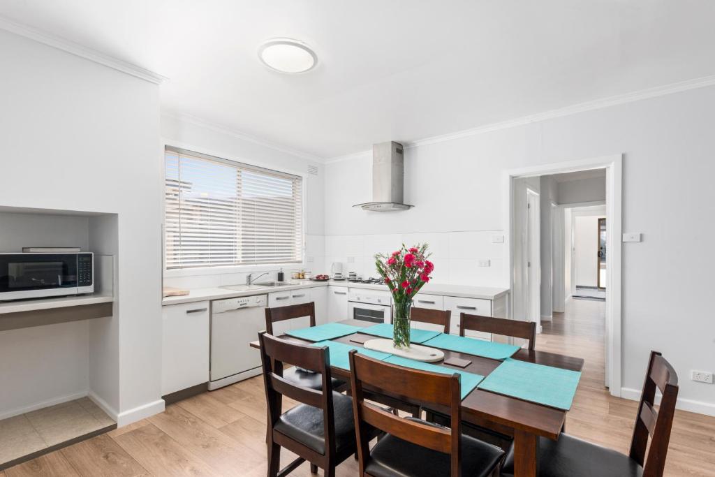 a kitchen and dining room with a table and chairs at Wattle Grove Villa in Maryborough