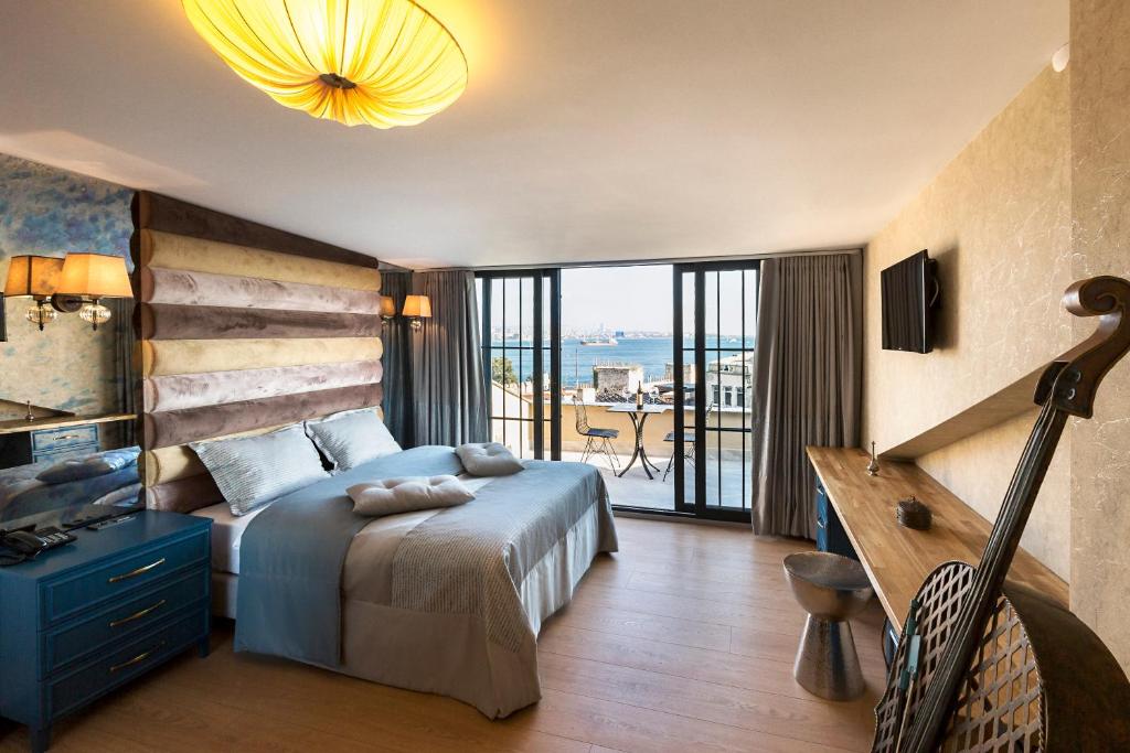 a bedroom with a bed and a view of the ocean at Sublime Porte Hotel in Istanbul