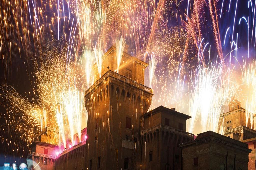 a firework display in front of a building with fireworks at Adelphi Room & Breakfast in Ferrara