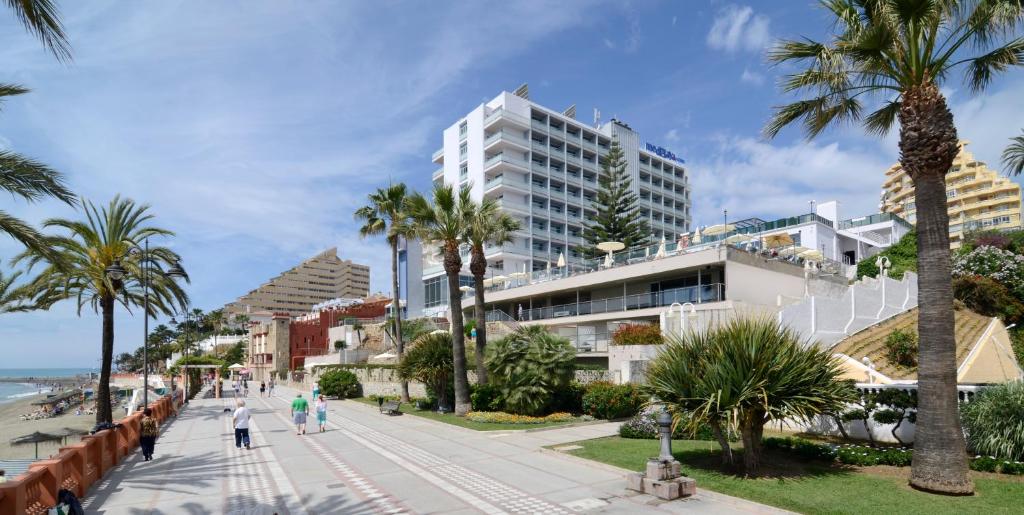 a city street with palm trees and palm trees at Medplaya Hotel Riviera - Adults Only in Benalmádena