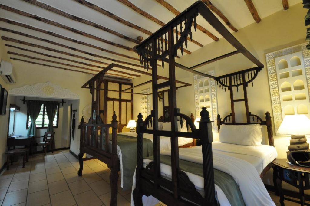 Postel nebo postele na pokoji v ubytování Kilifi Bay Beach Resort