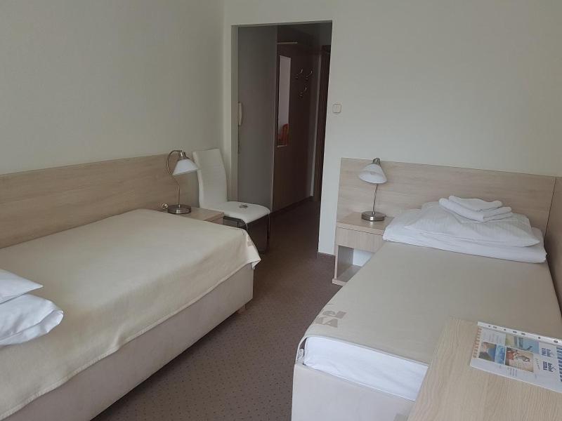 Postel nebo postele na pokoji v ubytování Hotel Ustka