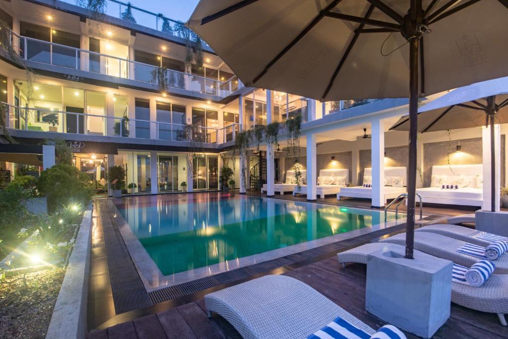 a swimming pool in front of a building at Levels Unawatuna in Unawatuna