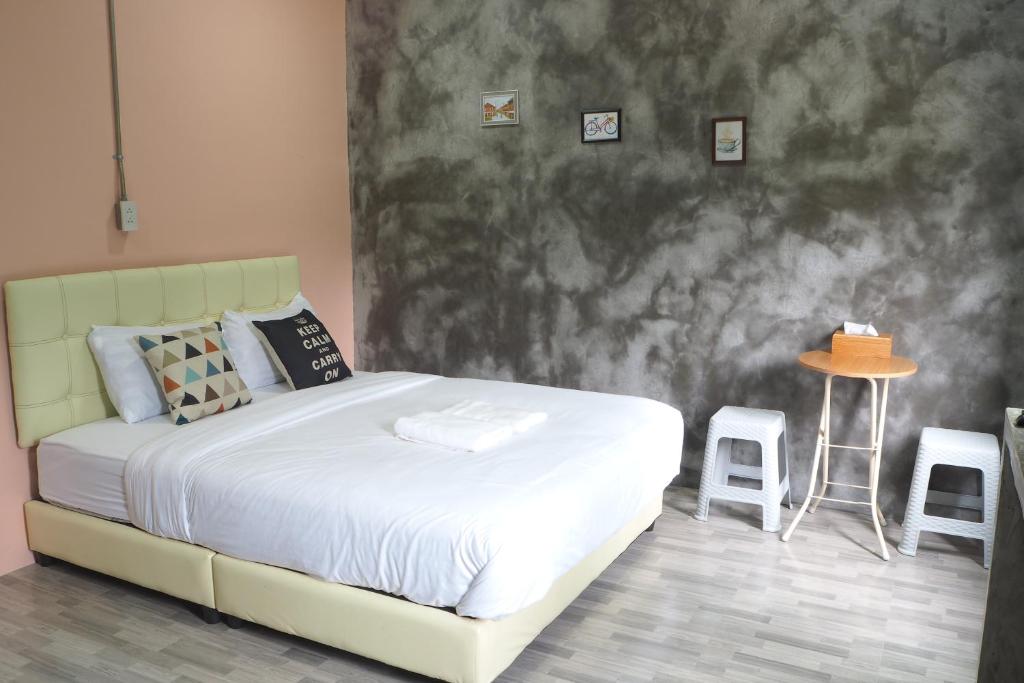 Postel nebo postele na pokoji v ubytování บ้านแก่งรีสอร์ท เชียงคาน