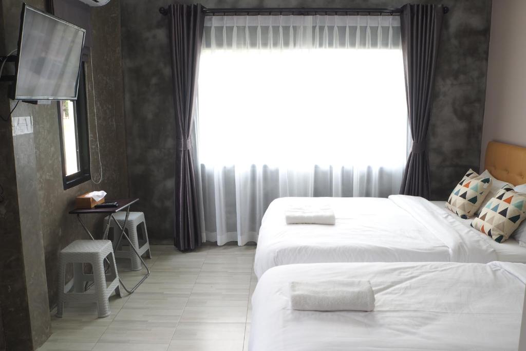 Postel nebo postele na pokoji v ubytování บ้านแก่งรีสอร์ท เชียงคาน