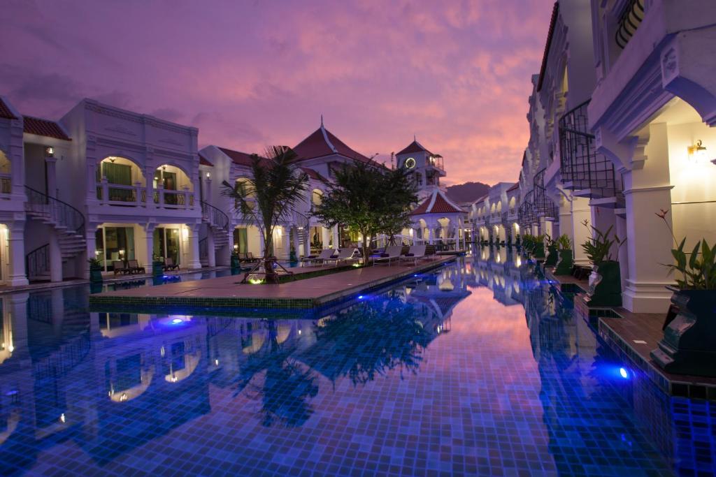 a swimming pool in a courtyard of a building at Supicha Pool Access Hotel - SHA Plus in Phuket Town