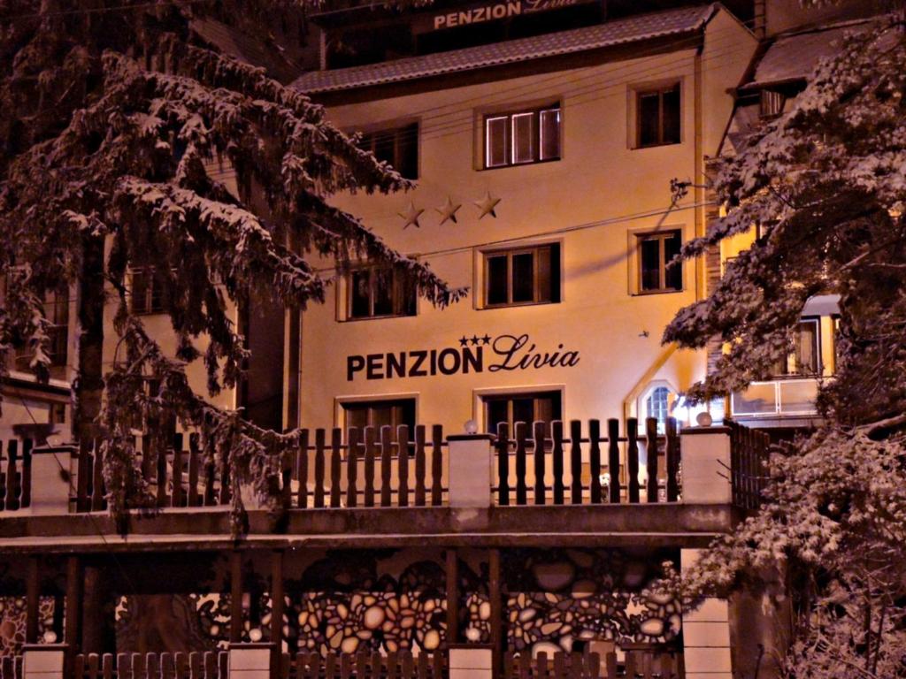 a building with a sign on the side of it at Penzionlivia,Tr.teplice in Martinske Hole