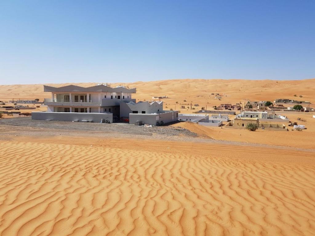 a building in the middle of a desert at Home X4 in Al Wāşil