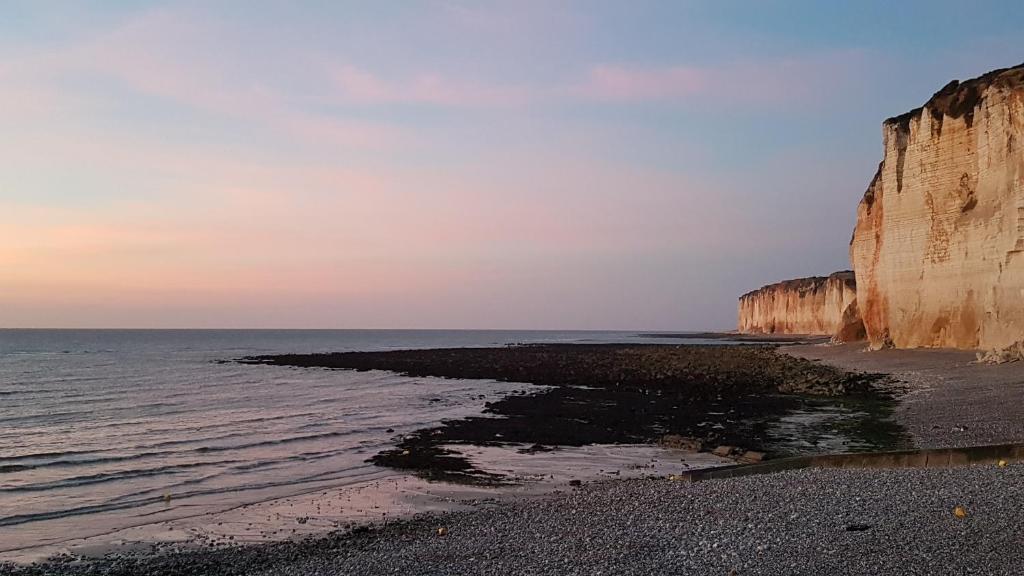 a view of the beach next to two cliffs at Villa Violaine in Sassetot-le-Mauconduit