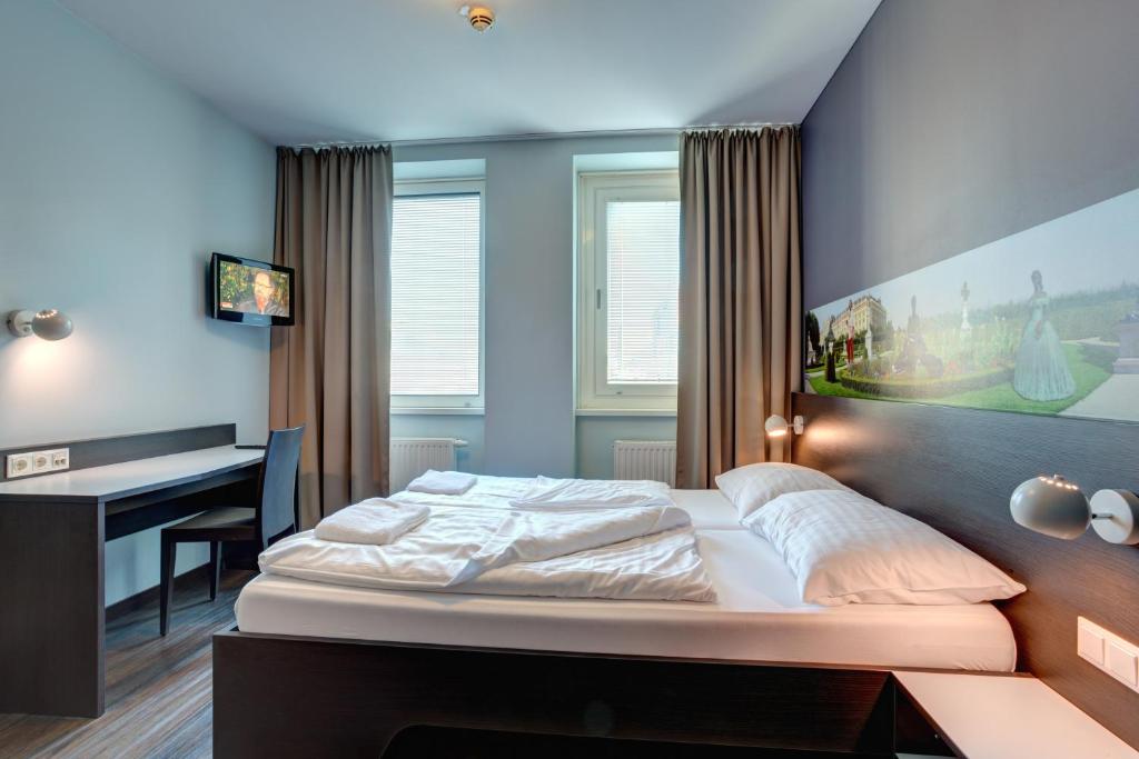 Postel nebo postele na pokoji v ubytování MEININGER Hotel Wien Downtown Sissi