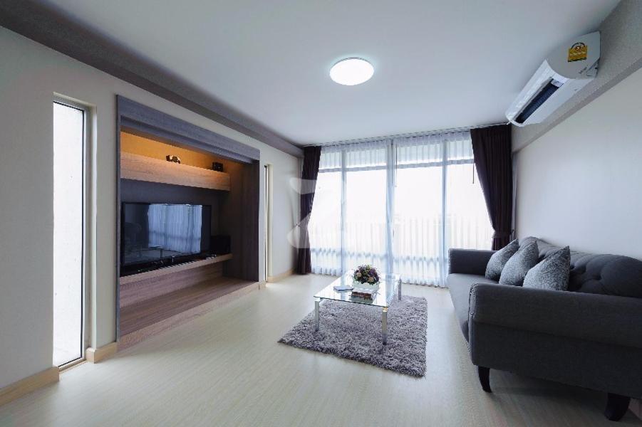 a living room with a couch and a tv at 21C Riviera Up Condominium in Pak Kret