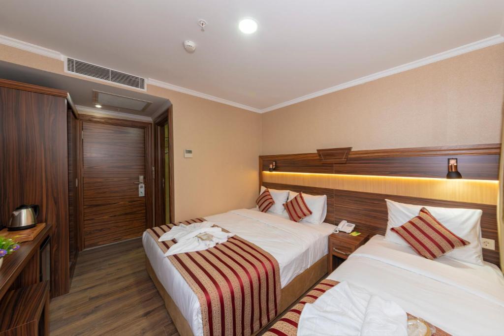 Postel nebo postele na pokoji v ubytování Vision Deluxe Hotel