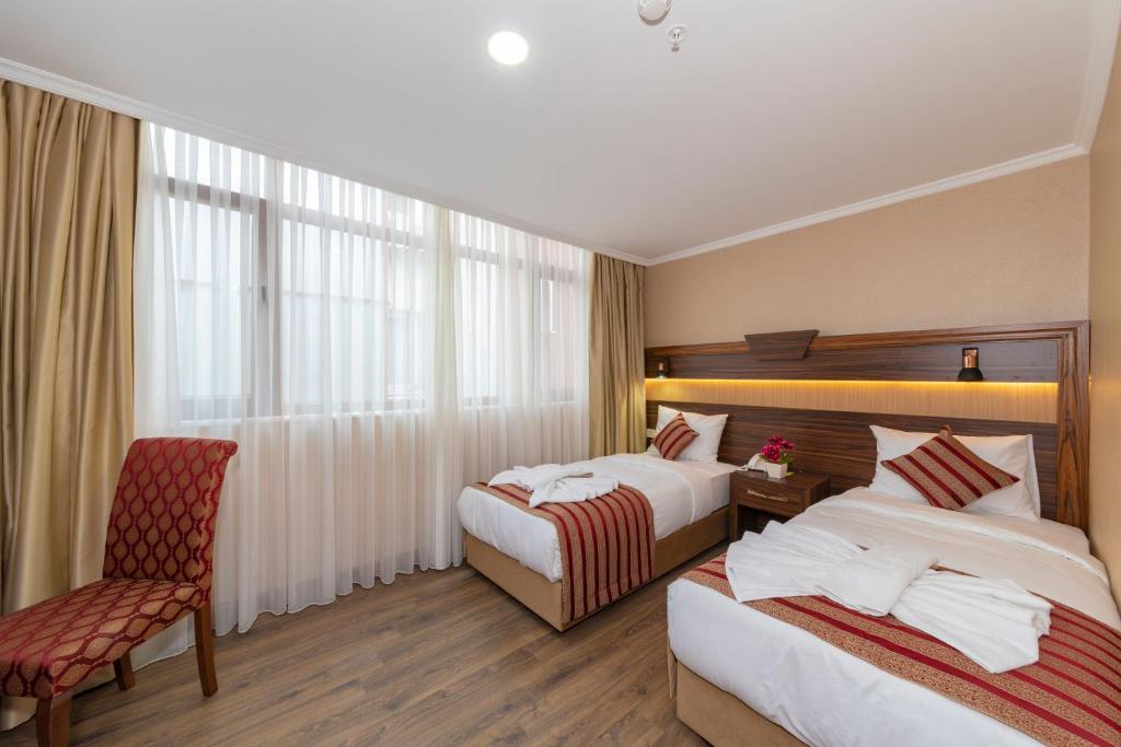Postel nebo postele na pokoji v ubytování Vision Deluxe Hotel