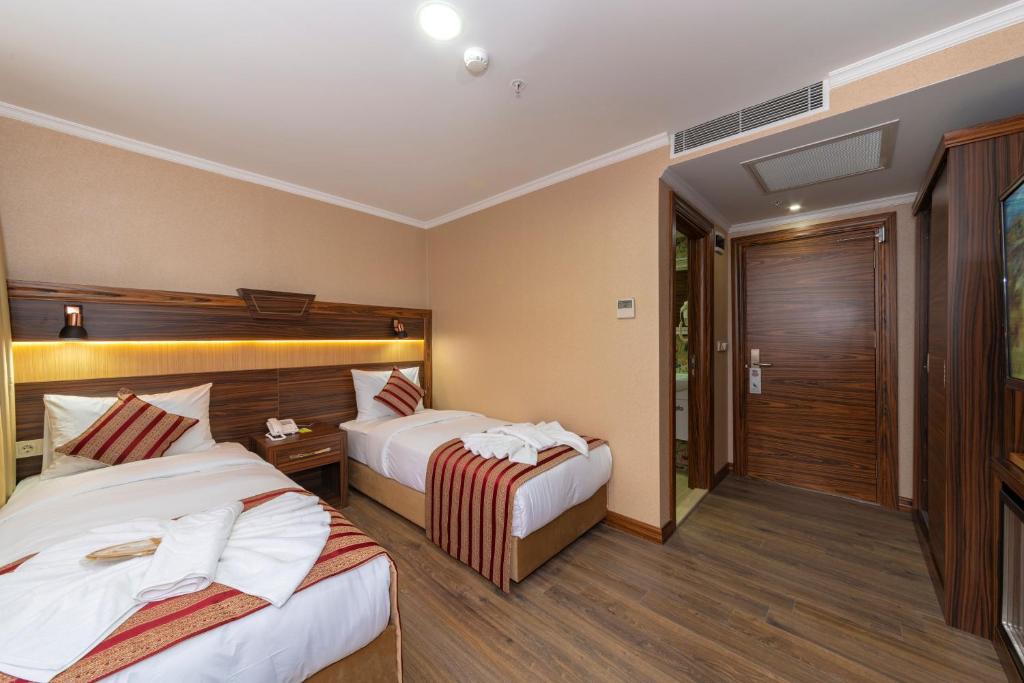 Postel nebo postele na pokoji v ubytování Vision Deluxe Hotel