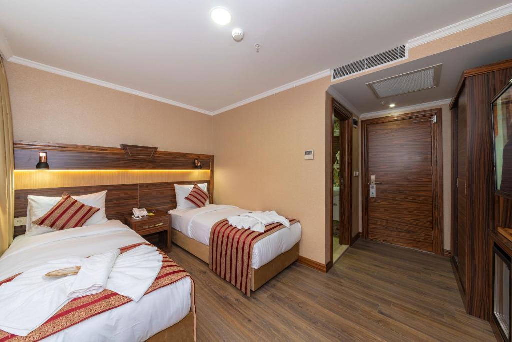 Postel nebo postele na pokoji v ubytování Vision Deluxe Hotel