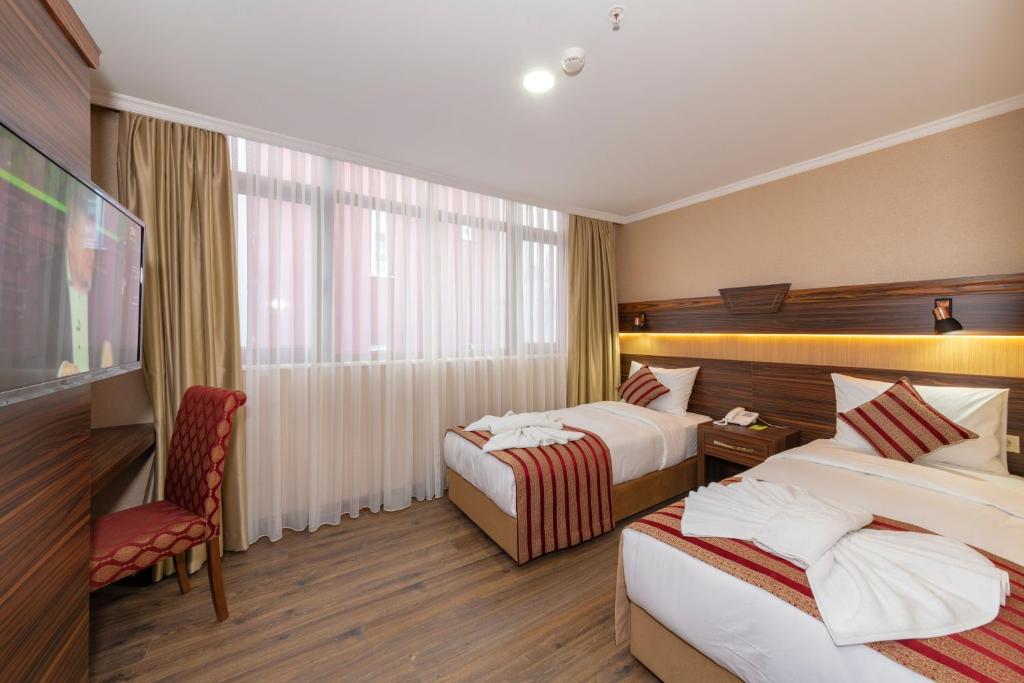 Postel nebo postele na pokoji v ubytování Vision Deluxe Hotel