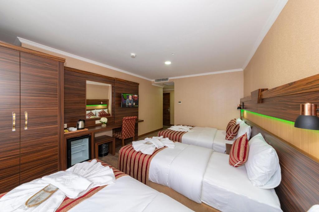 Postel nebo postele na pokoji v ubytování Vision Deluxe Hotel