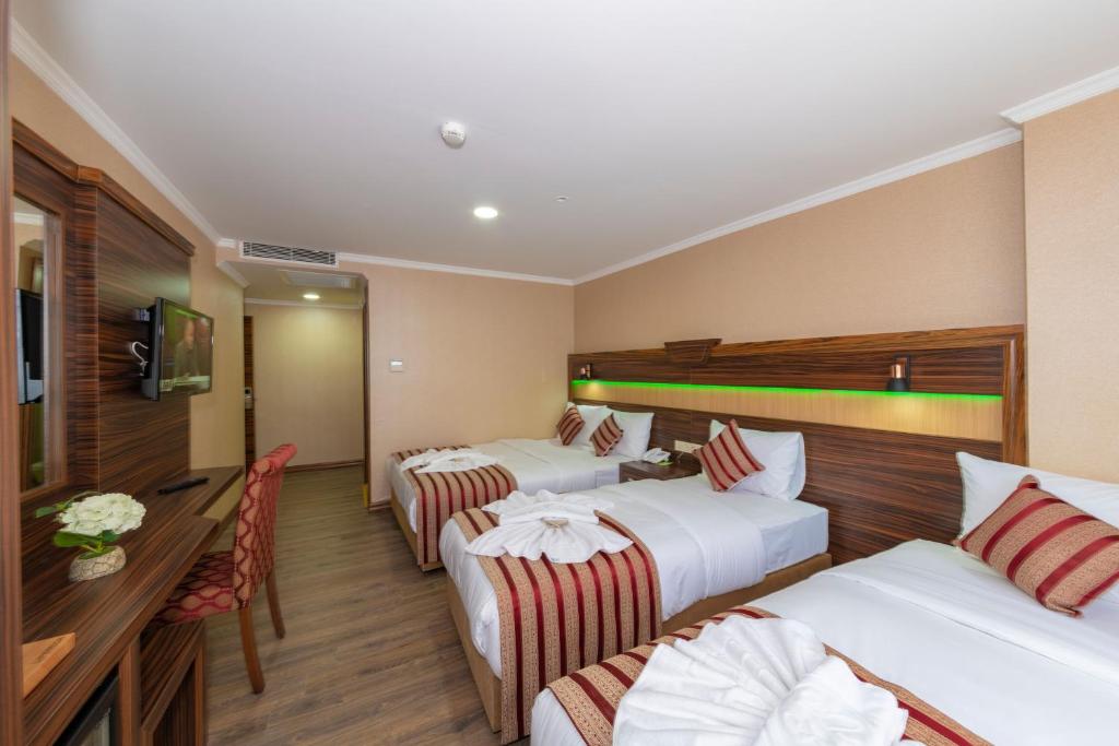 Postel nebo postele na pokoji v ubytování Vision Deluxe Hotel