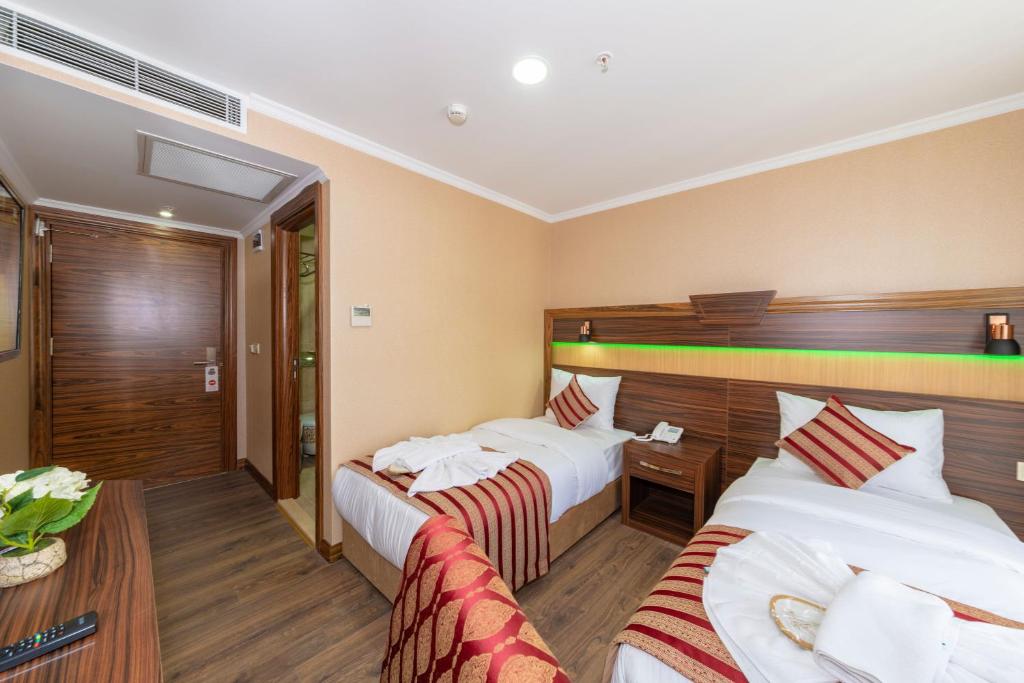 Postel nebo postele na pokoji v ubytování Vision Deluxe Hotel
