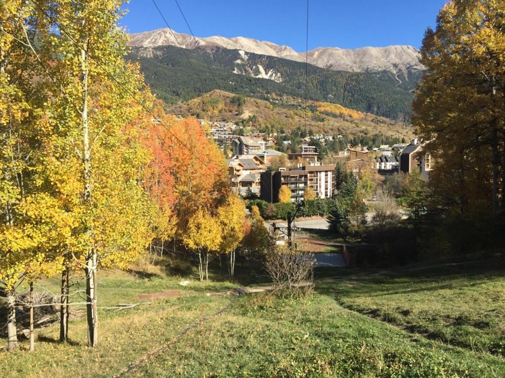 a view of a city with trees and mountains at Serre Chevalier -Cosy Apartment &quot;Le Coolidge&quot; for 7 down the slopes with stunning view in Saint-Chaffrey