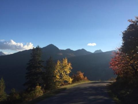 a road with trees on the side of a mountain at Serre Chevalier -Cosy Apartment &quot;Le Coolidge&quot; for 7 down the slopes with stunning view in Saint-Chaffrey