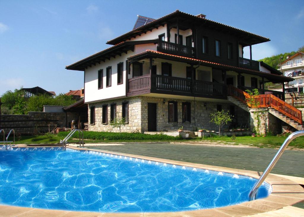 a house with a swimming pool in front of a house at Chorbadji Petkovi Hanove in Obzor