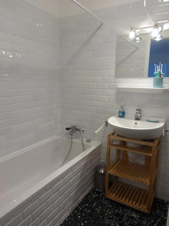 a bathroom with a white tub and a sink at Serre Chevalier -Cosy Apartment &quot;Le Coolidge&quot; for 7 down the slopes with stunning view in Saint-Chaffrey