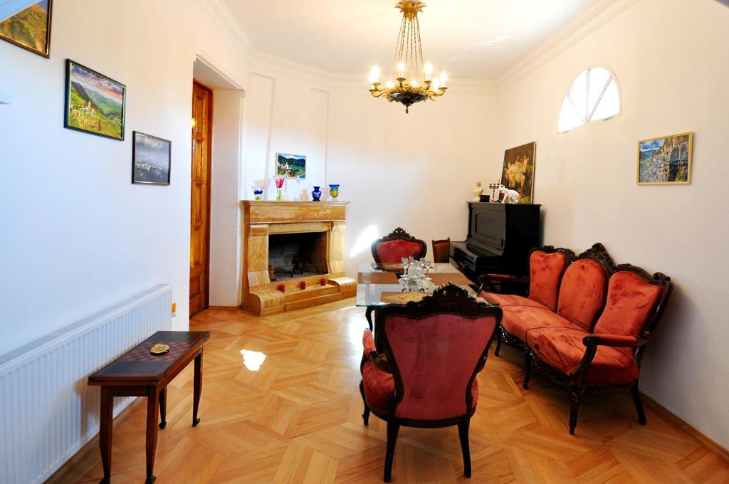 a living room with a couch and a fireplace at Vorontsov Old Tbilisi in Tbilisi City