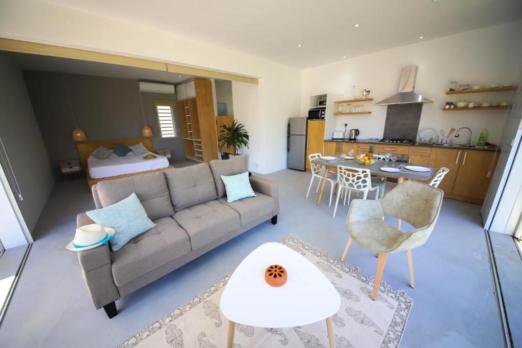 a living room with a couch and a table at Cap Heureux Villas in Cap Malheureux