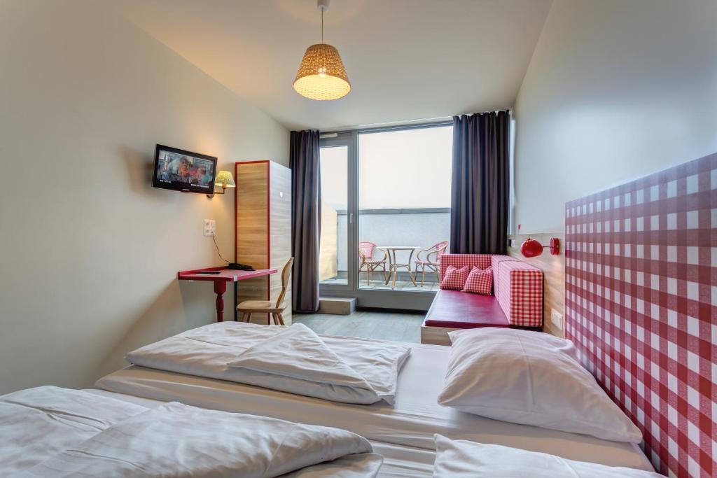 Cama o camas de una habitación en MEININGER Hotel Salzburg City Center
