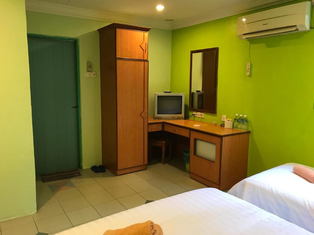 Postel nebo postele na pokoji v ubytování Hotel dan Restoran Seri Kangsar