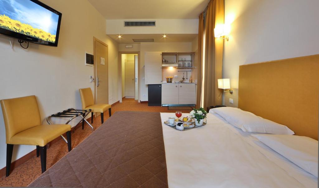 a hotel room with a bed and a living room at Regal Residence in Brescia