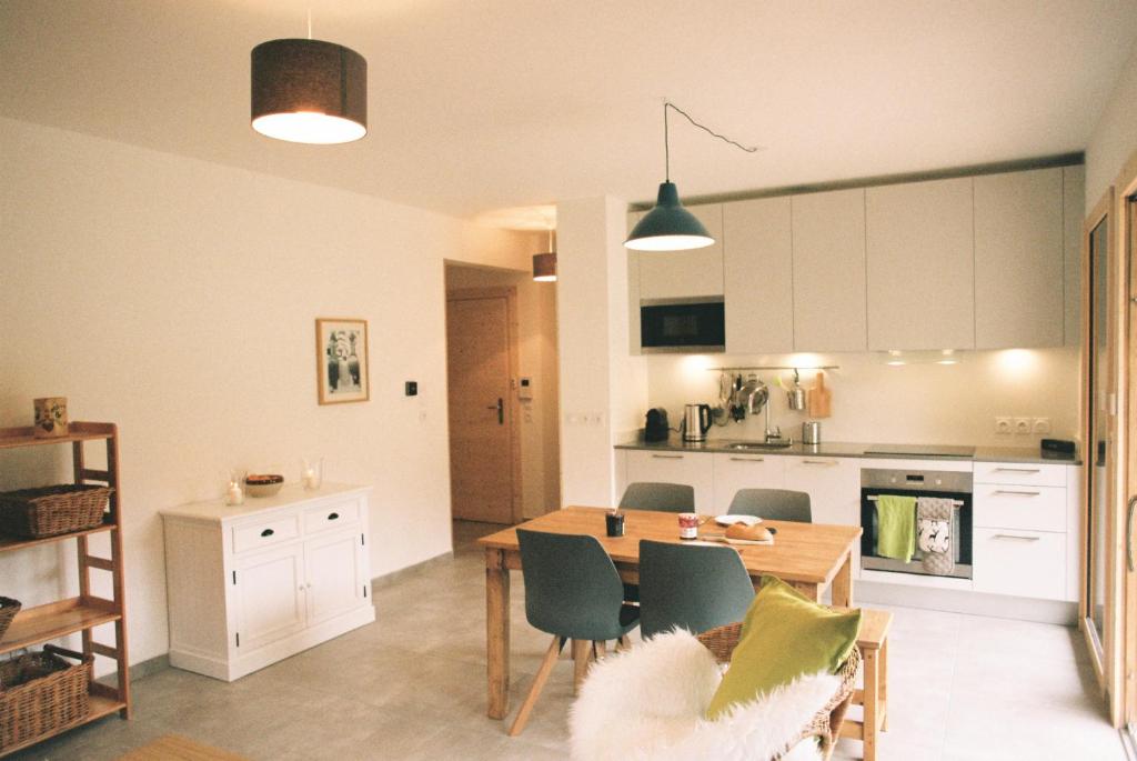 a kitchen and dining room with a table and chairs at Django in Les Gets