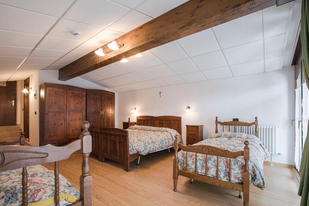 Postel nebo postele na pokoji v ubytování GH Hotel Fratazza