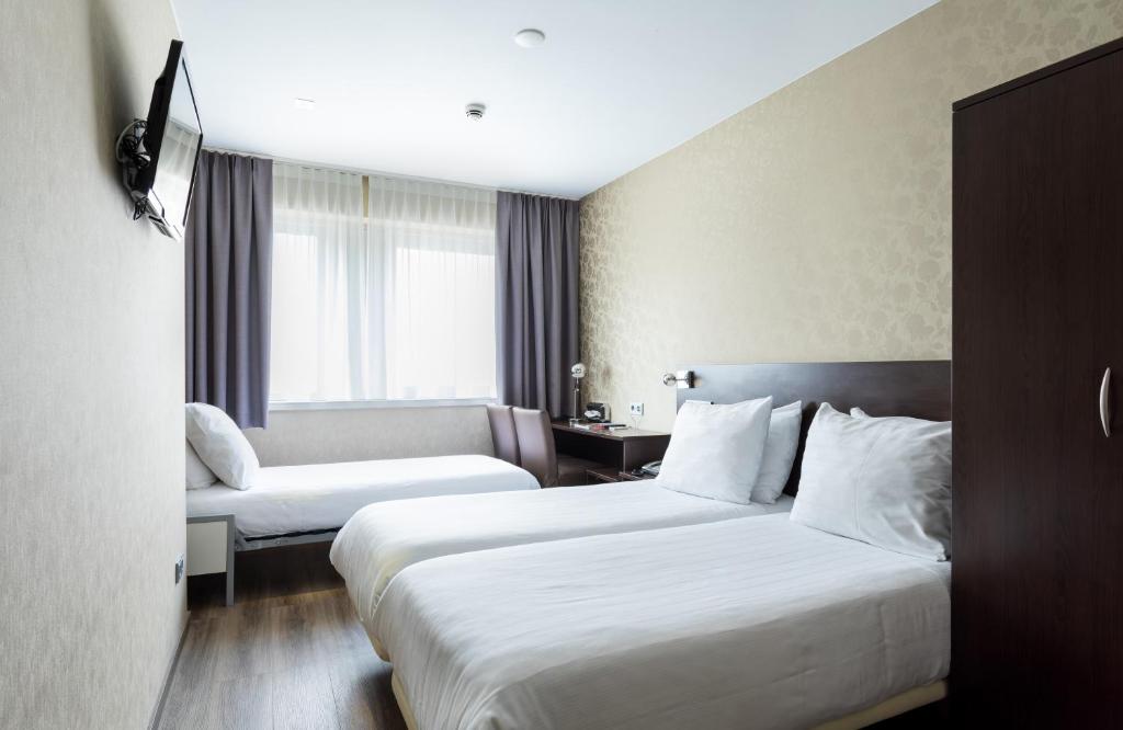 Ein Bett oder Betten in einem Zimmer der Unterkunft Hotel Espresso